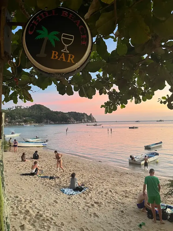 Chill Beach Bar sign with sunset over Chalok Bay